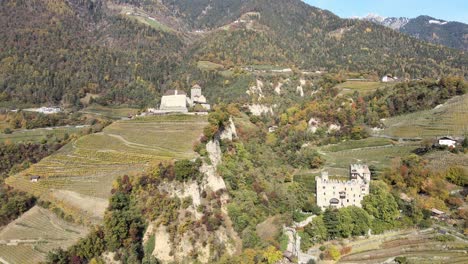 Aerial-Drone-Over-a-medieval-Castle-in-the-middle-of-the-Vineyards-in-Italy