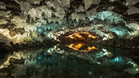 captivating crystal cavern: a journey through the stunning reflections and unique geology of an underground cave featuring remarkable ice-like formations
