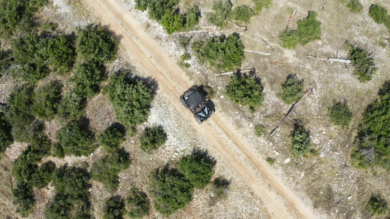 Close Up of Single Fast Dune Buggy Travelling Along Dusty Road, Aerial View