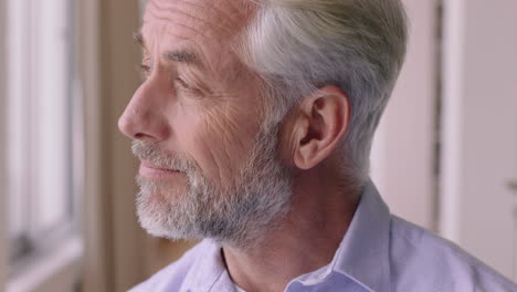 portrait happy old man smiling confident looking out window enjoying retirement lifestyle planning ahead relaxing at home