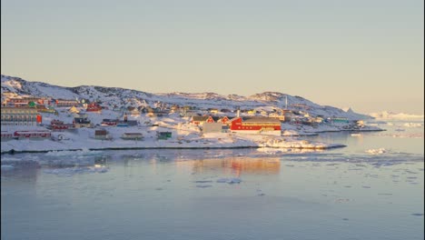 sunlit town on coastline of ice and sea
