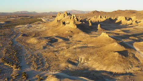 looking down at the trona pinnacles in the mojave desert during a bright yellow sunrise