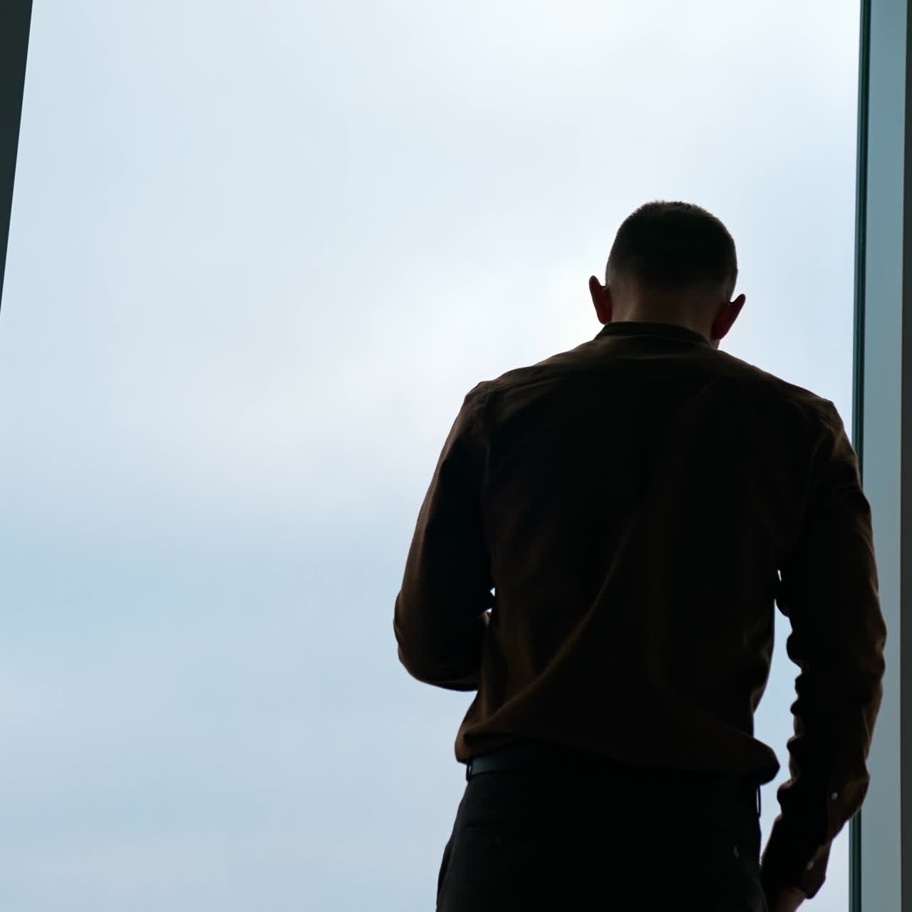 Handsome businessman writing notes from smartphone at modern office