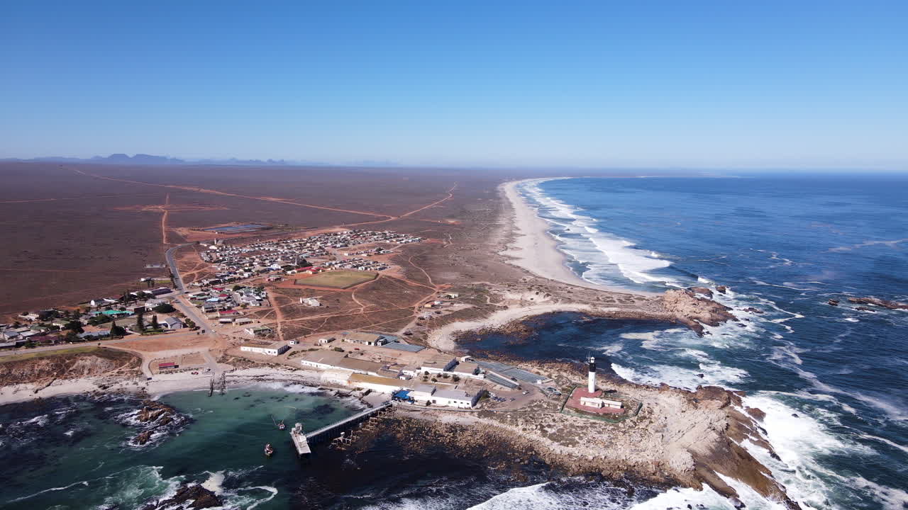 High aerial panoramic view over Fryer's Cove, lighthouse and pristine coast