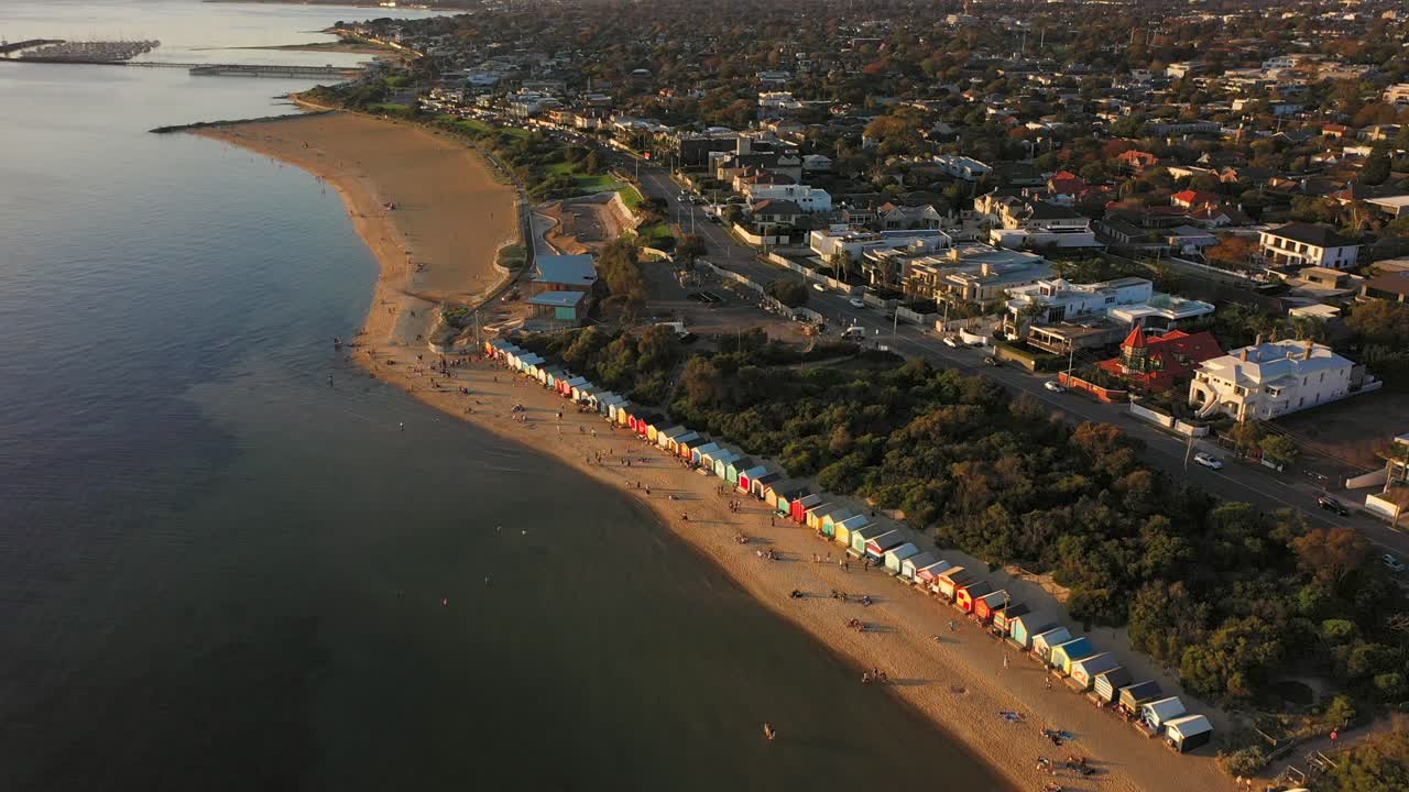 Drone footage overlooking Brighton's colourful bathing boxes in Melbourne, Australia