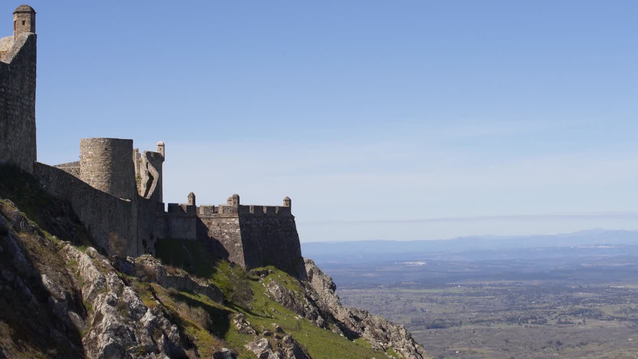 Marvao castle on the top of a mountain with beautiful green landscape behind on summer, in Portugal