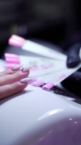 woman in a nail salon receiving a manicur