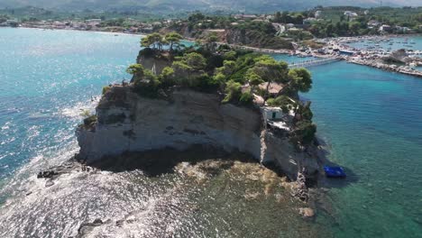 Drone-Shot-of-Cameo-Island,-Scenic-Landmark-of-Zakynthos-Island,-Greece-With-Agios-Sostis-Harbor-in-Background