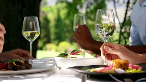 group of friends having breakfast and wine