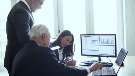 group of finance professionals analyzing stock market charts