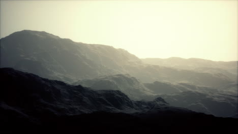 silhouette-of-swiss-alps-mountains-in-morning-clouds