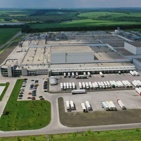 industrial plant on nature background. large territory of industry with parking for trucks. modern factory on field. aerial view.