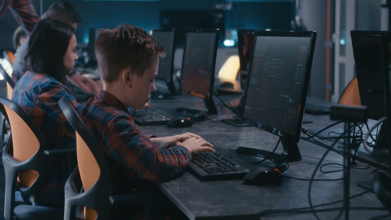 Children in a computer class learning coding