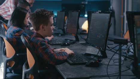 Children in a computer class learning coding