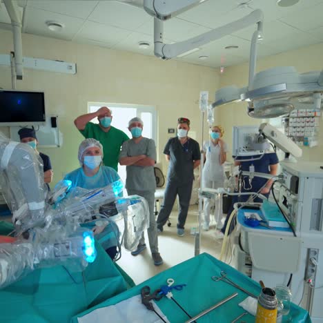 robotic arm for minimal invasive surgery. team of surgeons performing delicate operation using arm medical surgical robot