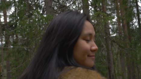 Girl-walking-in-the-forest-smiling.-slowmotion