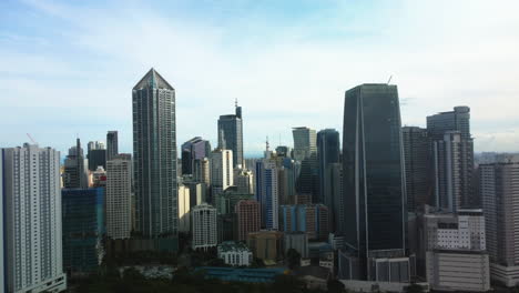 aerial orbit shot in front of the makati skyline, in sunny manila, philippines