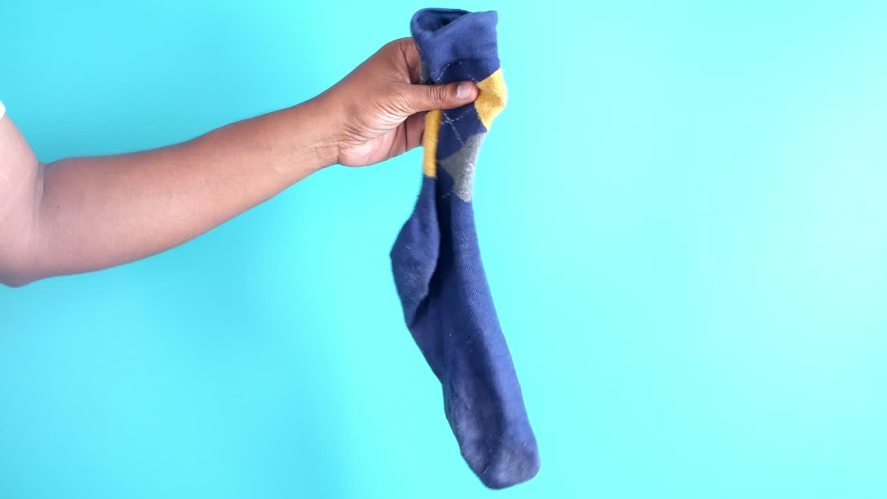 un primer plano de una persona con un calcetín azul.