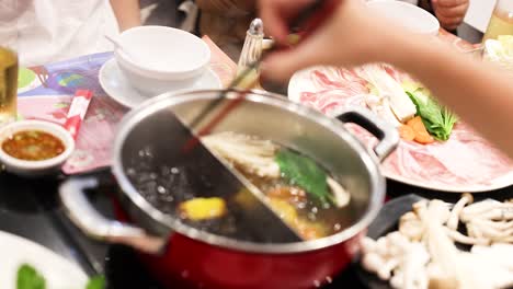 cooking and sharing food at a hotpot meal