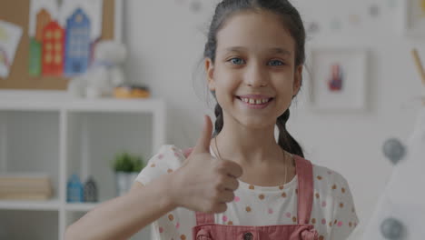 smiling girl with thumbs up