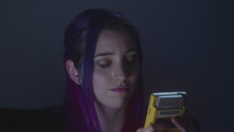 young woman playing videogames on her portable device