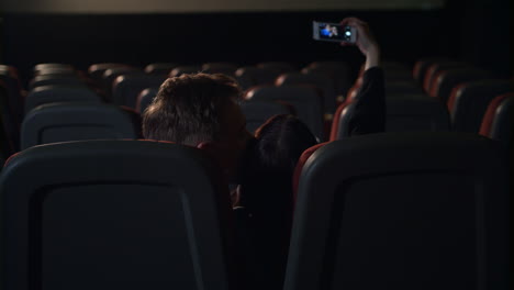 young people kissing in empty cinema hall