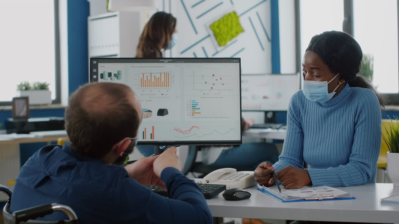 Multiethnic colleagues with masks working in new normal startup company