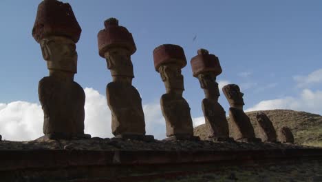 easter island statues stand in a long row