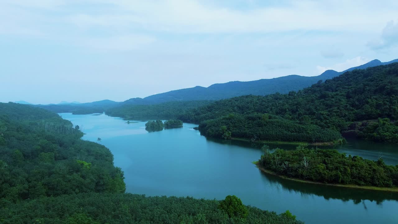 Serene Lake Surrounded by Lush Green Mountains