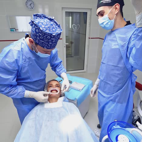 dentist preparing female patient for dental treatment. treatment of teeth in a modern clinic. restoration of a healthy smile.