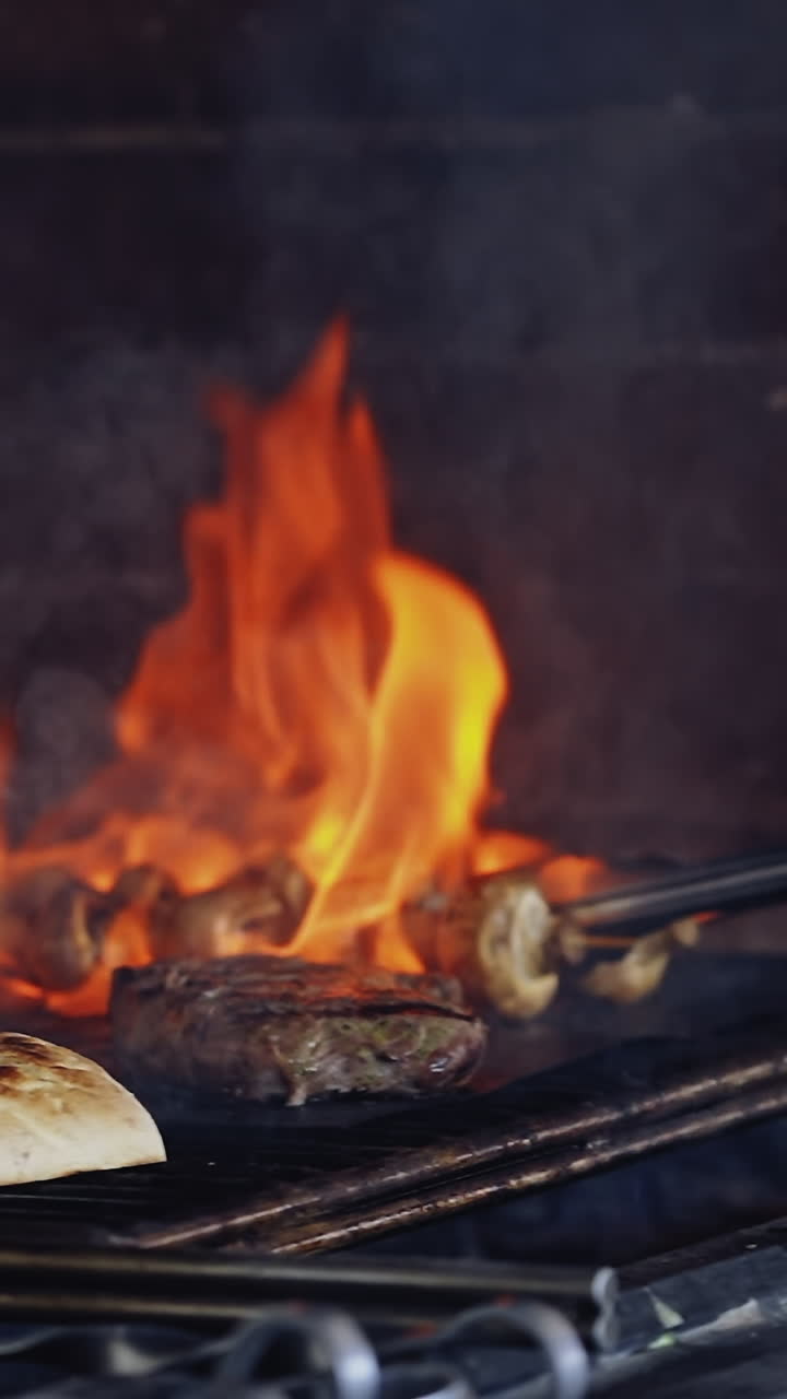 Cooking food in fire. Delicious meal on grid preparation by chef ...
