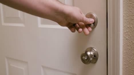 hand closing door and locking deadbolt and handle