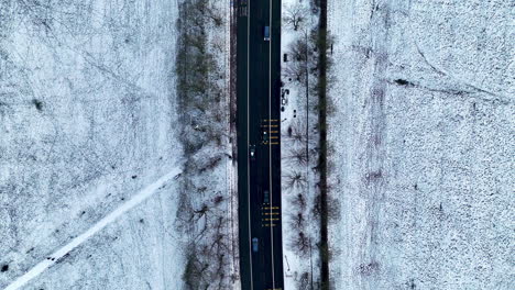 Top-down-aerial-of-snow-either-side-of-the-road-in-Newcastle-Upon-Tyne