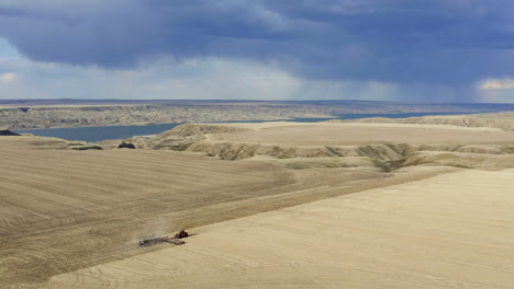 aerial view of agricultural tractor seeding crops on the field in saskatchewan, canada