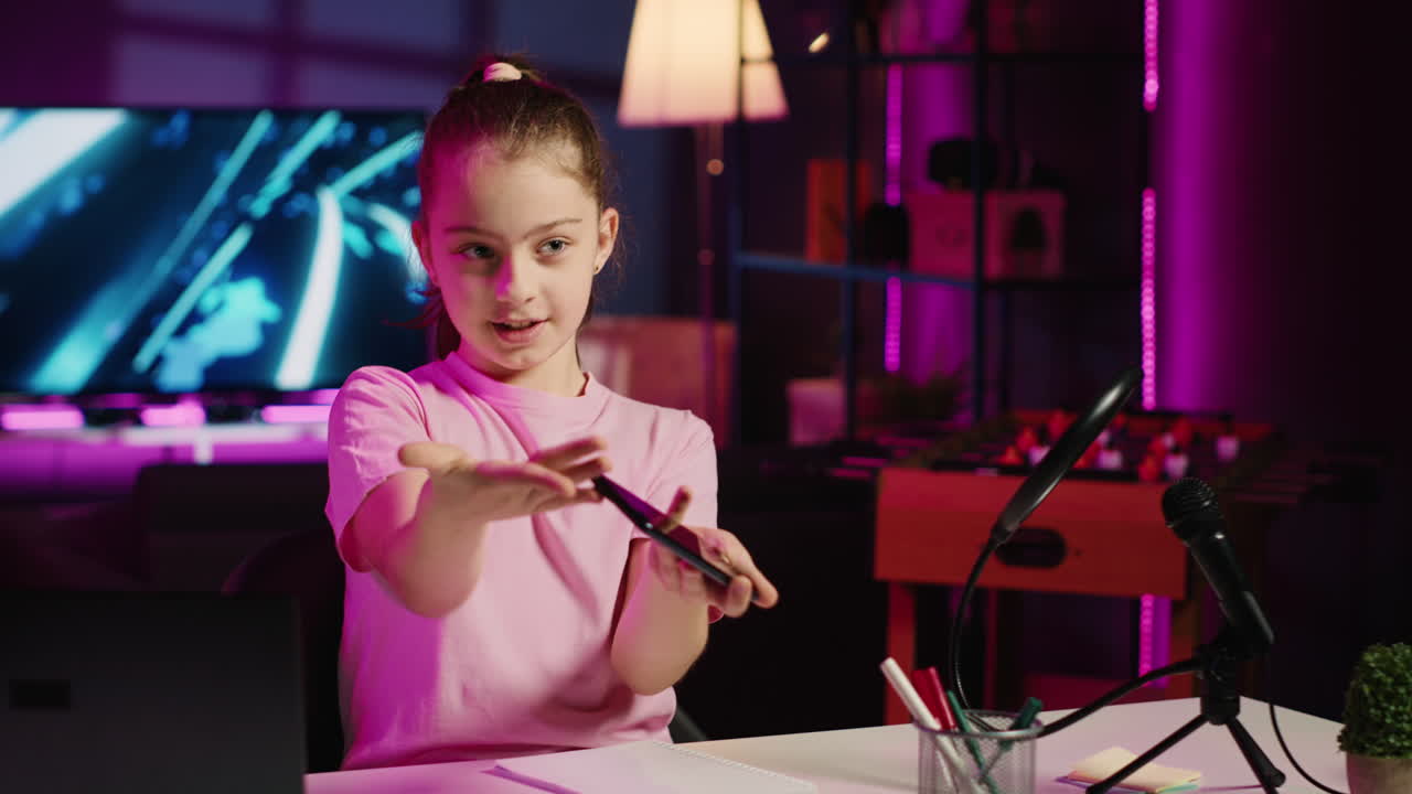 Kid content creator filming technology review of newly released ...