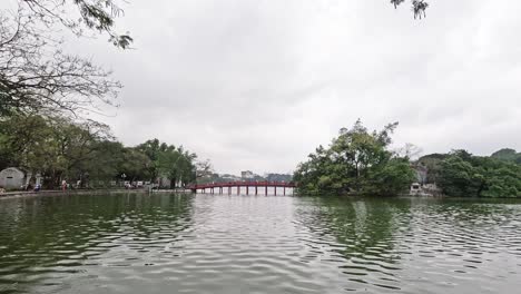 agua tranquila, árboles y el icónico puente rojo