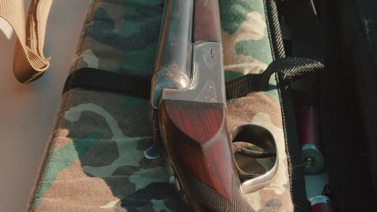 Shotgun resting on the gun case. The camera tilts down