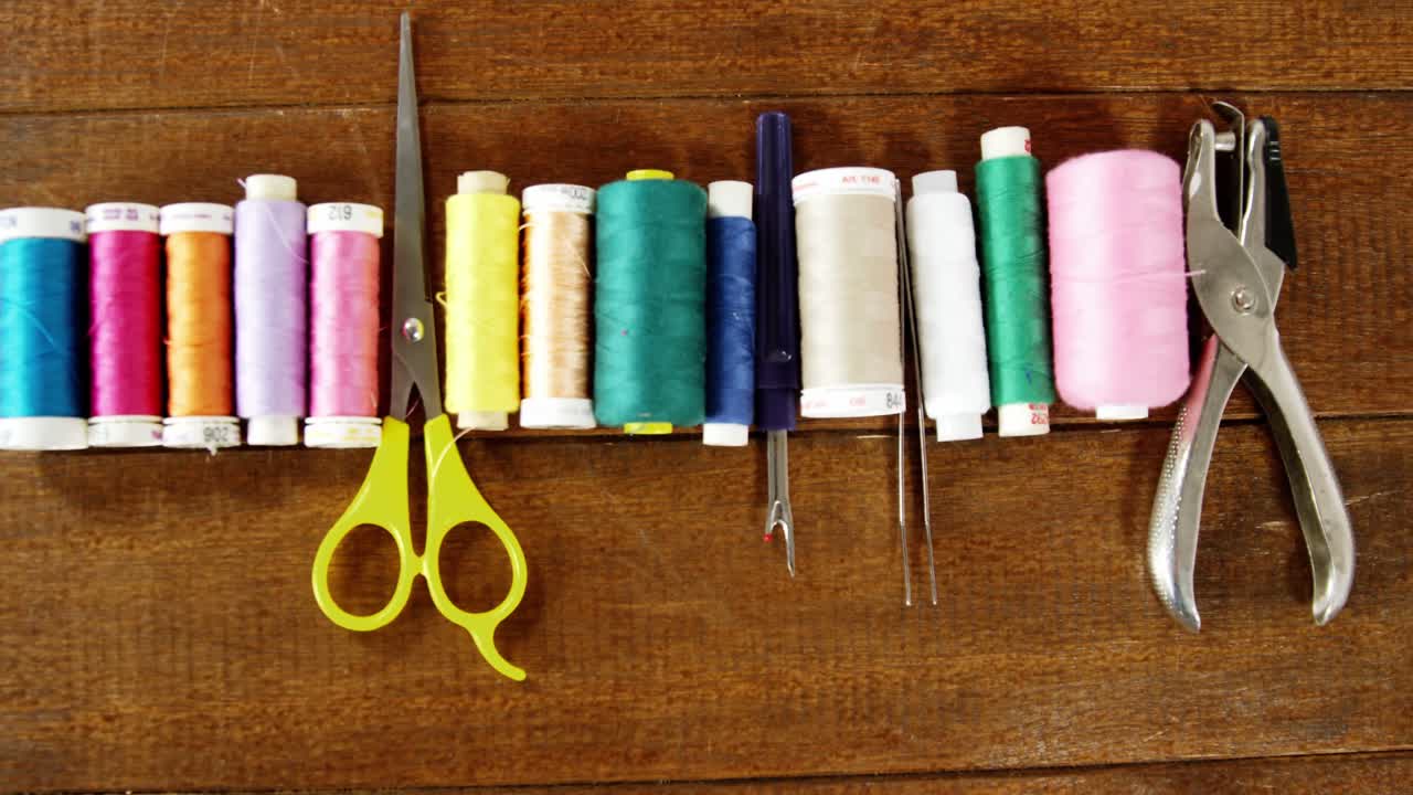 Close-up of set of threads and sewing tools
