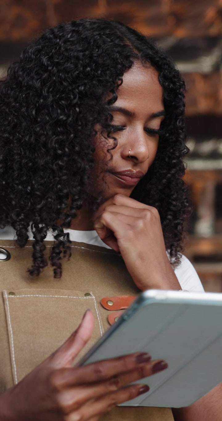 Young Woman Using Tablet in Cafe Setting