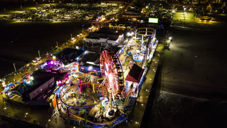 timelapse of a carnival and fair on santa monica pier during the night