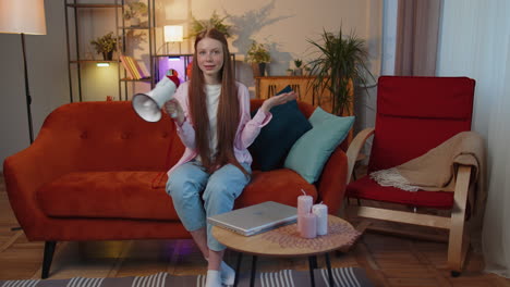 young teen child girl kid talking with megaphone, proclaiming news, loudly announcing advertisement