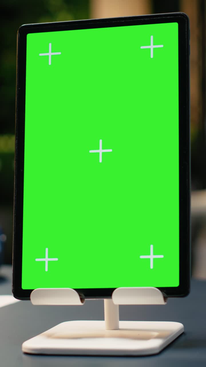 Vertical Video Vertical chroma key screen tablet in contemporary empty office workspace