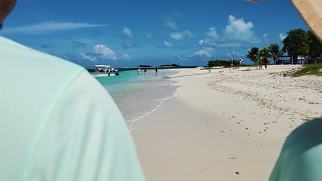 Back-view-of-Couple-walking-hands-to-hands-ON-WHITE-SAND-BEACH-looking-to-caribbean-sea,-honeymoon-concept