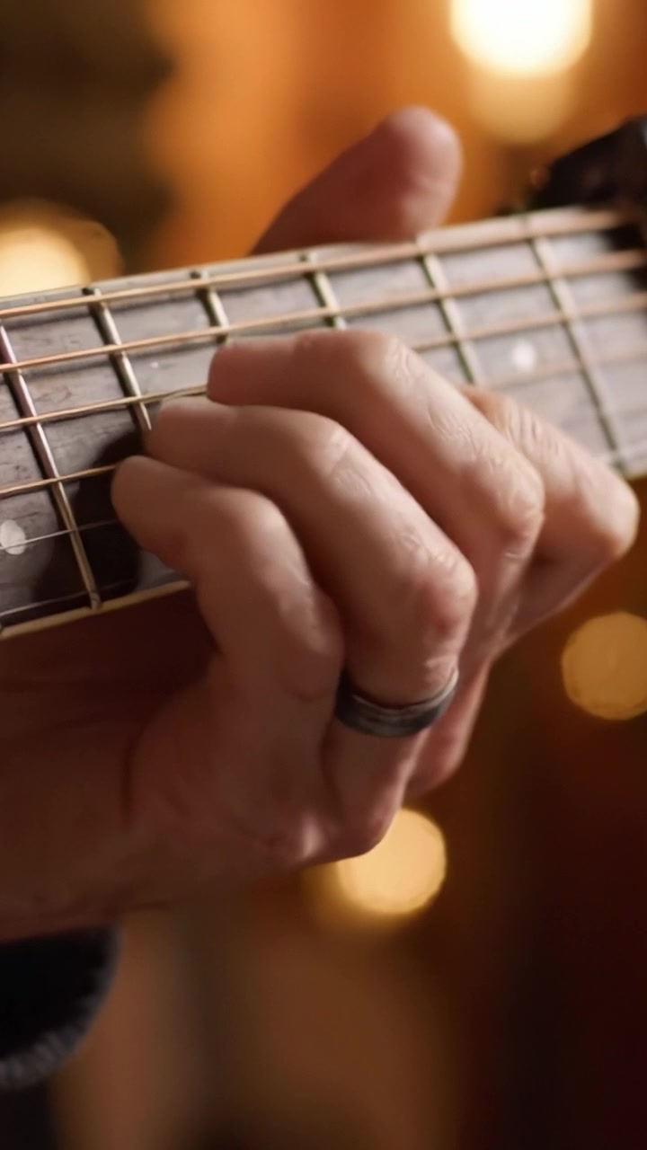 An Intimate Close-Up of a Guitar Player's Hand Skillfully Fretting Chords on the Neck of a Beautiful Acoustic Guitar, Capturing the Essence of Music Creation