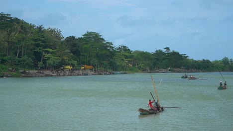 fishermen on typical indonesian boat, bogowonto river in purworejo city