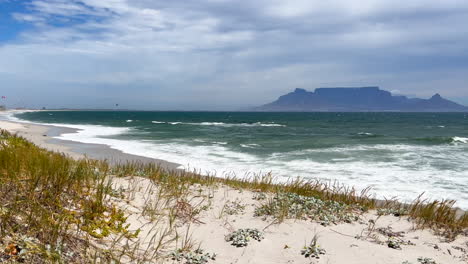 cape town south africa sunset beach sunny windy spring summer day kite boarding table mountain view white sand gorgeous beach slow motion pan to the left