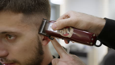 man getting a haircut at the barber shop