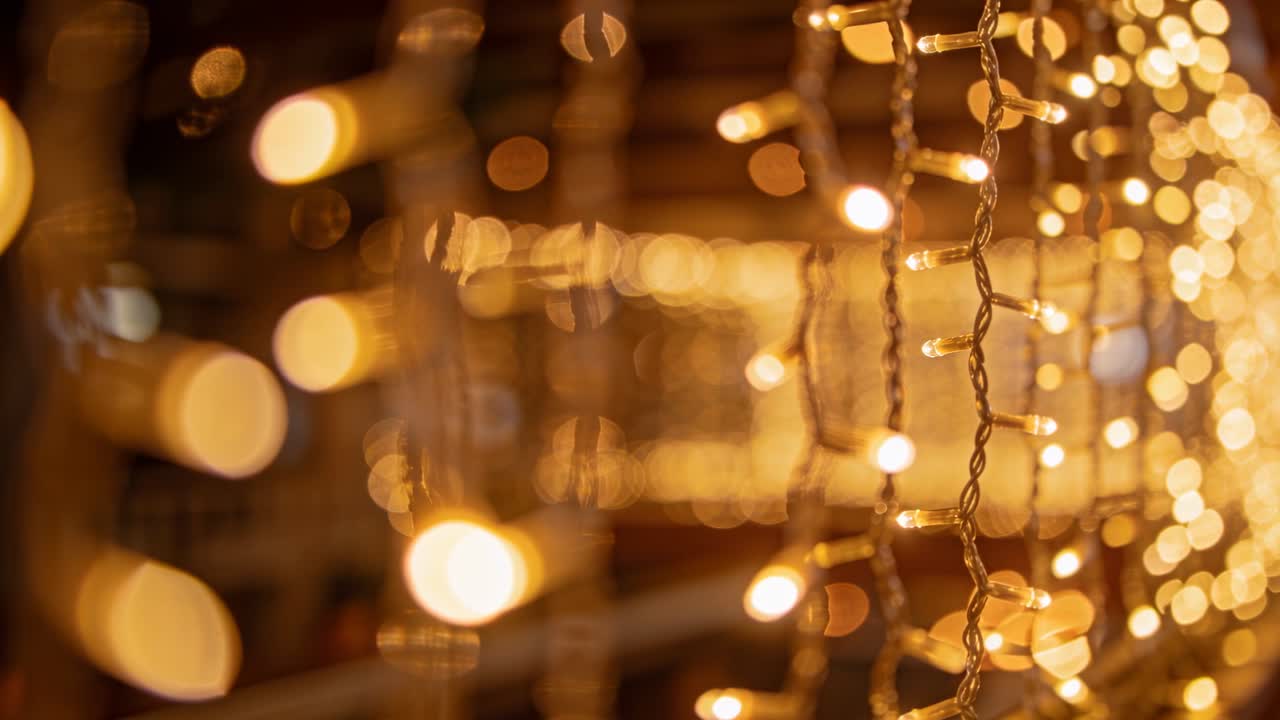 Camera pulling focus, fairy lights sharpening while golden bokeh drifting, showing event decor