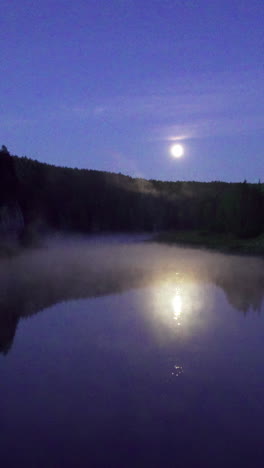 full moon over misty river