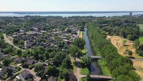 aerial drone shot above the sity of almere haven with a gooilake on background, province flevoland, netherlands